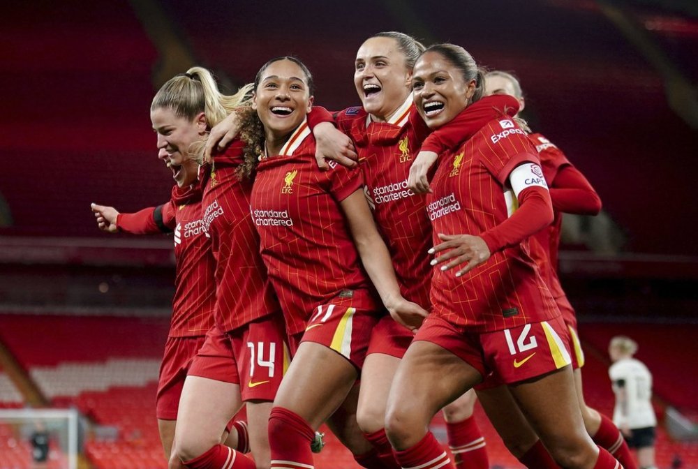 Liverpool's Olivia Smith, second left, celebrates with her team mates after scoring her sides third goal from the penalty spot during their English Women's Super League match at Anfield, Liverpool, England, Friday, March 14, 2025. (Peter Byrne/PA via AP)