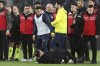 Galatasaray's coach Okan Buruk, bottom, lies on the ground after Fenerbahce's manager Jose Mourinho, center, grabbed his nose at the end of the Turkish Cup quarterfinals soccer match between Fenerbahce and Galatasaray at the Ulker stadium, in Istanbul, Wednesday, April 2, 2025. (Murat Akbas/Dia Photo via AP)