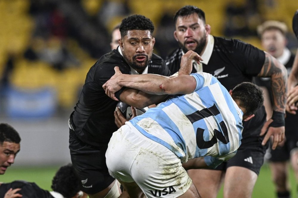 FILE - Argentina's Lucio Cinti, right, tackles New Zealand's Ardie Savea, left, during their rugby union test match in Wellington, New Zealand on Aug. 10, 2024. (Andrew Cornaga/Photosport via AP, File)
