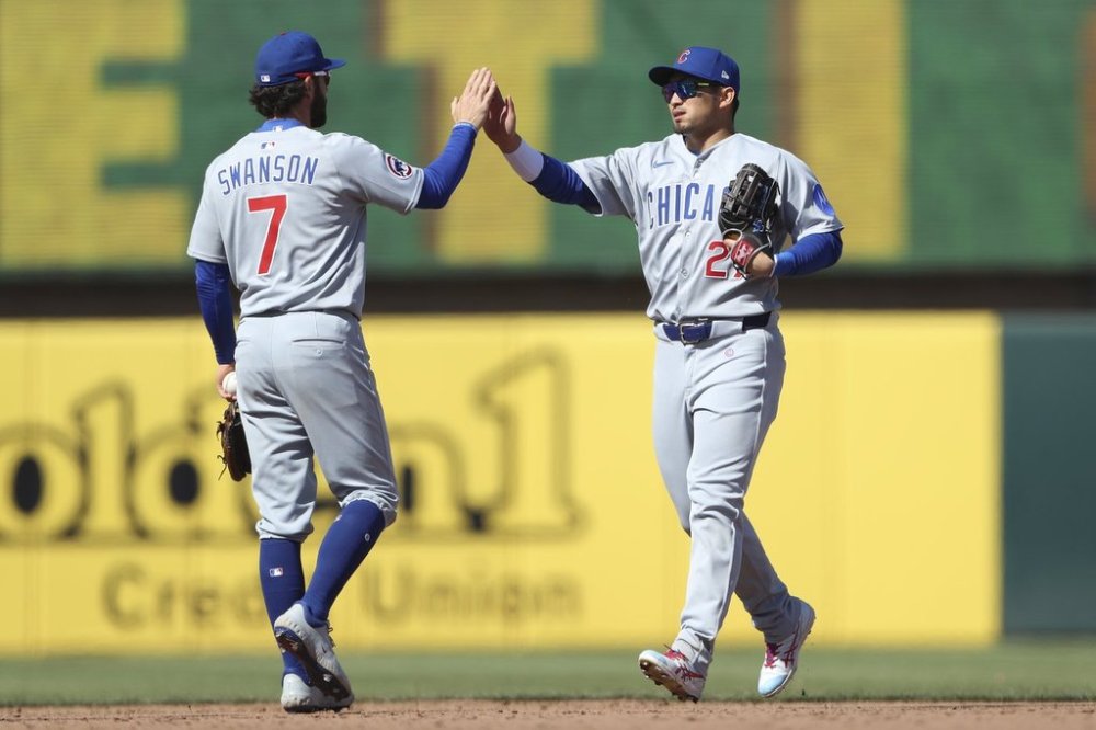 Chicago Cubs shortstop Dansby Swanson (7) and Chicago Cubs right field Seiya Suzuki (27) celebrate together after their victory against the Athletics in a baseball game Wednesday, April 2, 2025, in West Sacramento, Calif. (AP Photo/Scott Marshall)