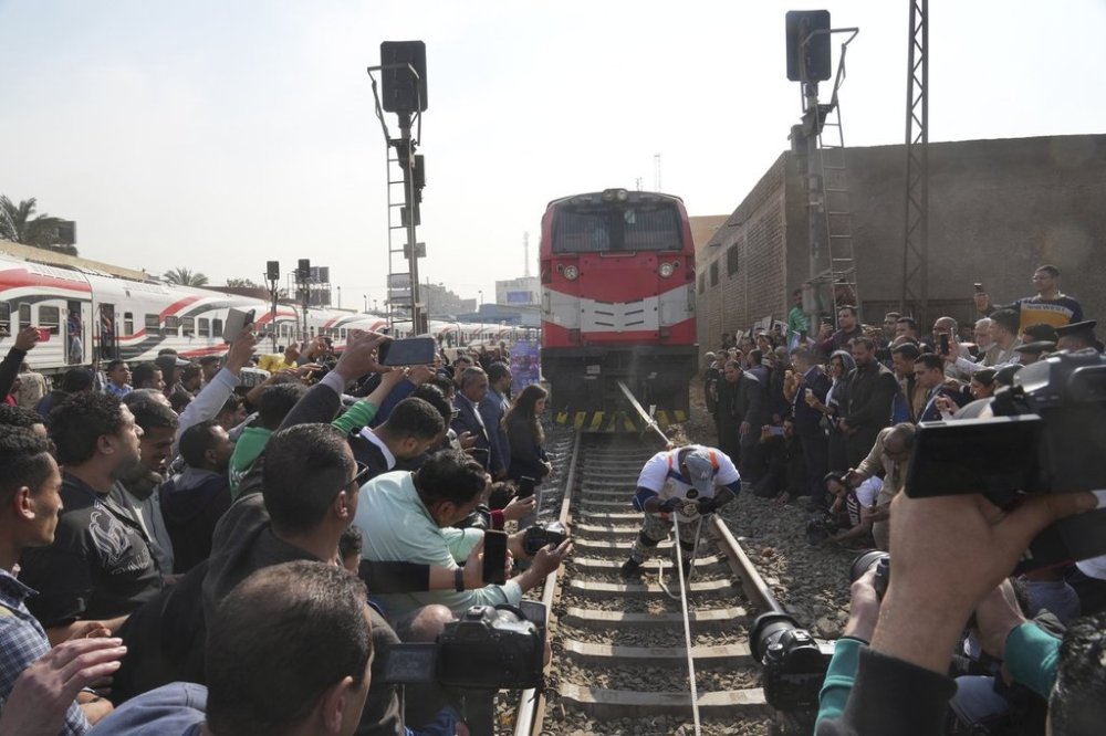 Egyptian wrestler Ashraf Mahrous, better known as Kabonga, pulls a train for nearly 10 meters, 33 feet, at Ramses Station in Cairo, Egypt, as he is watched by Guinness World Record observers, Thursday, March 13, 2025. (AP Photo/Amr Nabil) ID: