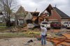 Ryland Mosley, 18, who was on the 2nd story of his home when the storm passed, stands outside of it observing the damage, Wednesday, April 2, 2025 in Owasso, Okla. (Mike Simons/Tulsa World via AP)