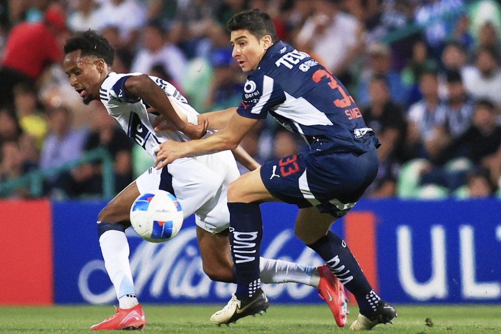Ali Ahmed of Canada's Vancouver Whitecaps, left, and Stefan Medina of Mexico's Monterrey fight for the ball during a CONCACAF Champions Cup soccer match at Corona stadium in Torreon, Mexico, Wednesday, March 12, 2025. (AP Photo/Jesus Gonzalez)