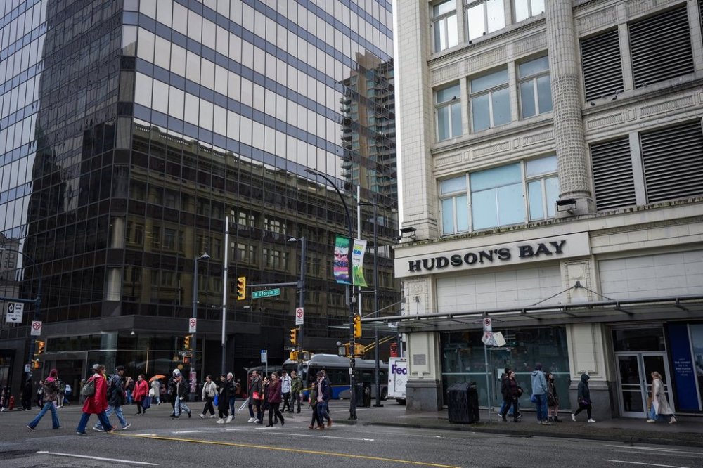 People walk past the flagship downtown Hudson's Bay store in Vancouver, on Monday, March 24, 2025. THE CANADIAN PRESS/Darryl Dyck