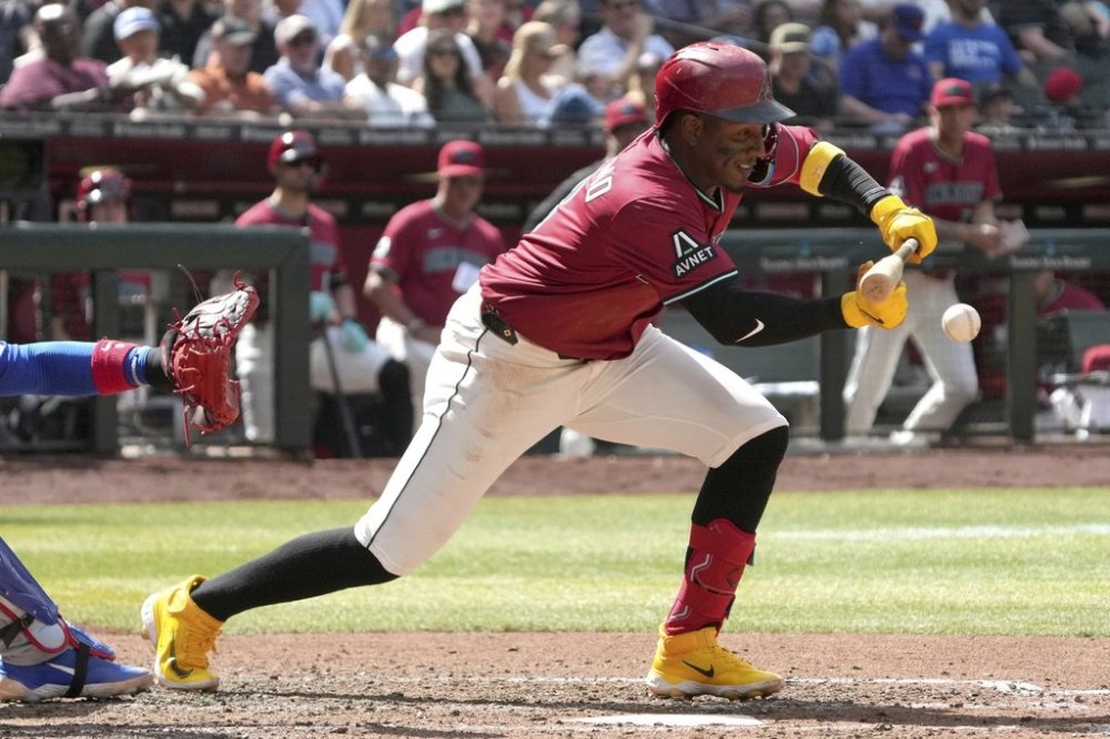 Arizona Diamondbacks' Geraldo Perdomo lays down a sacrifice bunt against the Chicago Cubs in the fifth inning during a baseball game, Sunday, March 30, 2025, in Phoenix. (AP Photo/Rick Scuteri)