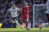 Fulham's Andreas Pereira, left, challenges for the ball with Liverpool's Virgil van Dijk during the English Premier League soccer match between Fulham and Liverpool, at Craven Cottage, London, Sunday, April 6, 2025. (AP Photo/Kin Cheung)