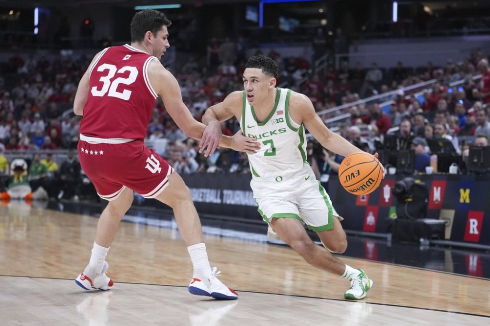 Oregon guard Jackson Shelstad (3) drives on Indiana guard Trey Galloway (32) during the first half of an NCAA college basketball game in the second round of the Big Ten Conference tournament in Indianapolis, Thursday, March 13, 2025. (AP Photo/Michael Conroy)