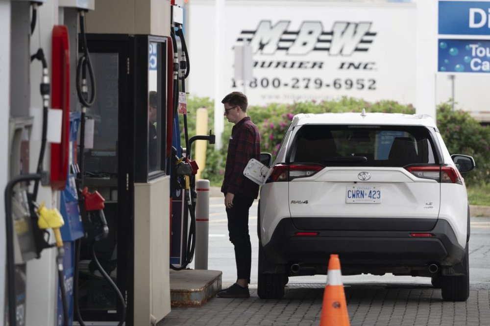 A motorist stands at the fuel pump to fill their tank before the new federal carbon pricing takes effect at midnight in Halifax, Friday, June 30, 2023. As of Tuesday, the price is $0. THE CANADIAN PRESS/Darren Calabrese