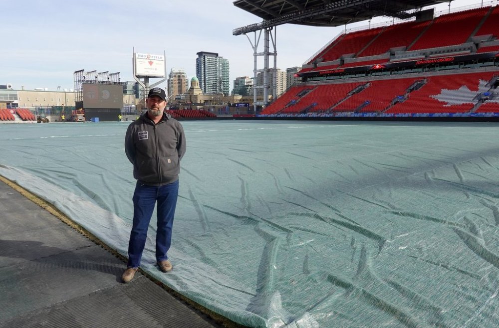 Robert Heggie, director of grounds at MLSE, is shown at BMO Field, in Toronto, Thursday, March 13, 2025, before the removal of the tarp covering the field ahead of Saturday's Toronto FC home opener against the Chicago Fire. THE CANADIAN PRESS/Neil Davidson