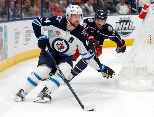 Winnipeg Jets defenseman Josh Morrissey, left, controls the puck in front of Columbus Blue Jackets forward Liam Foudy during the second period of an NHL hockey game in Columbus, Ohio, Thursday, Feb. 16, 2023. (AP Photo/Paul Vernon)