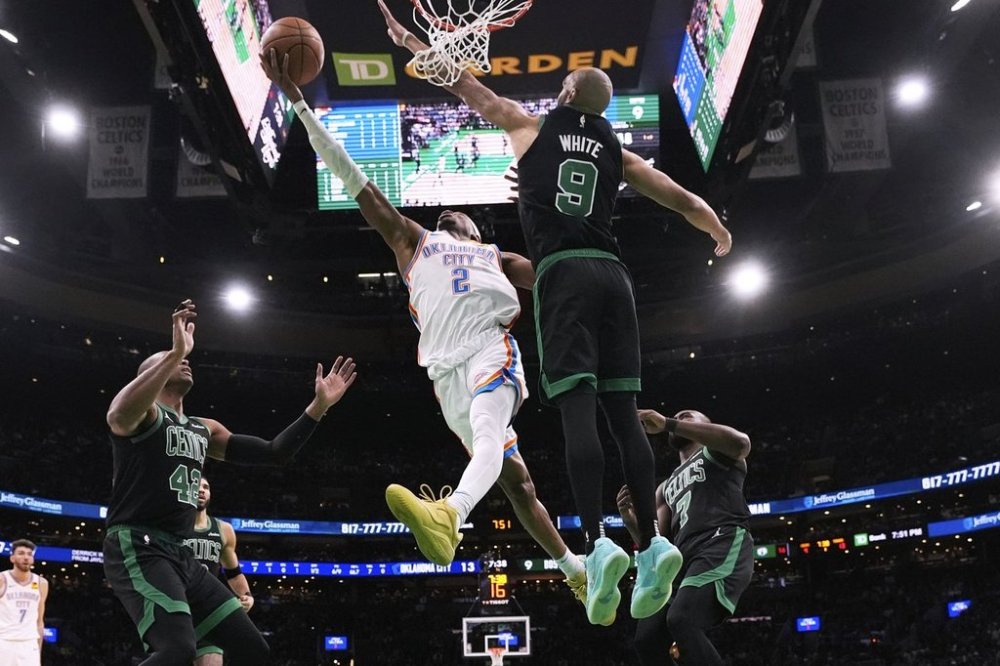 Oklahoma City Thunder guard Shai Gilgeous-Alexander (2) drive to the basket against Boston Celtics guard Derrick White (9) during the first half of an NBA basketball game, Wednesday, March 12, 2025, in Boston. (AP Photo/Charles Krupa)