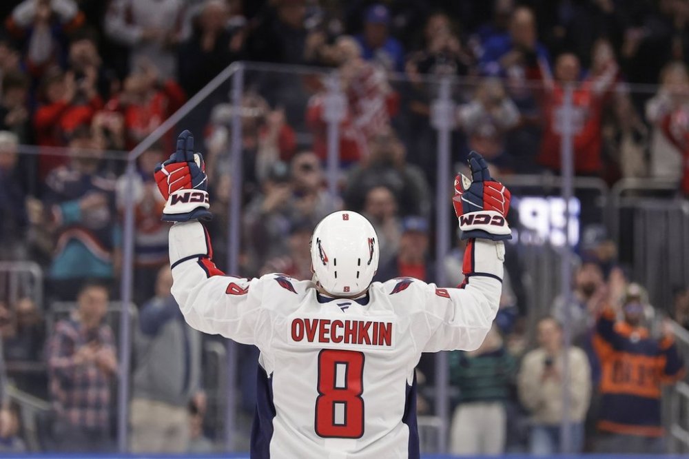 Washington Capitals left wing Alex Ovechkin (8) celebrates after scoring his 895th career goal during the second period of an NHL hockey game against New York Islanders in Elmont, N.Y., Sunday, April 6, 2025. (AP Photo/Adam Hunger)