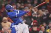 Toronto Blue Jays' George Springer follows through on an RBI single against the Boston Red Sox during fifth inning of a baseball game, Monday, April 7, 2025, in Boston. (AP Photo/Charles Krupa)