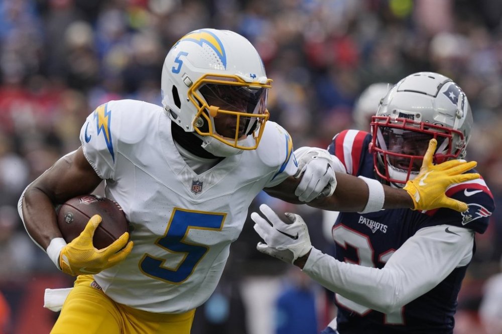FILE - Los Angeles Chargers wide receiver Joshua Palmer (5) evades New England Patriots cornerback Jonathan Jones (31) during the first half of an NFL football game, Dec. 28, 2024, in Foxborough, Mass. (AP Photo/Michael Dwyer, File)