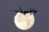 An Air Transat Airbus A330 is silhouetted against the full moon when approaching for landing in Lisbon just before sunrise, July 22, 2024. Travel company Transat A.T. Inc. reported a first-quarter net loss of $122.5 million, compared with a loss of $61 million in the same quarter last year. THE CANADIAN PRESS/AP/Armando Franca