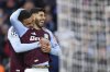 Aston Villa's Marco Asensio, right, celebrates with Aston Villa's Morgan Rogers after scoring his side's third goal during the Champions League round of 16 second leg soccer match between Aston Villa and Club Brugge at the Villa Park stadium in Birmingham, England, Wednesday, March 12, 2025. (AP Photo/Darren Staples)