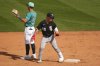 Chicago White Sox's Chase Meidroth looks on after hitting an RBI double as Seattle Mariners second baseman Dylan Moore motions to the outfield during the fifth inning of a spring training baseball game Saturday, March 1, 2025, in Peoria, Ariz. (AP Photo/Lindsey Wasson)