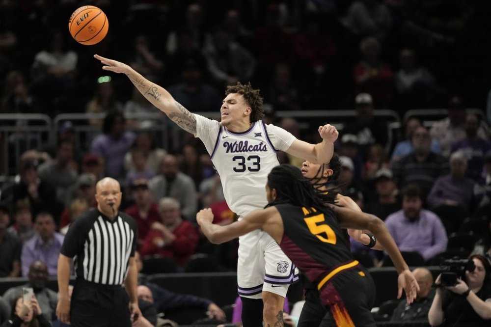 Kansas State's Coleman Hawkins (33) passes the ball as Arizona State's Amier Ali (5) defends during the first half of an NCAA college basketball game in the first round of the Big 12 Conference tournament, Tuesday, March 11, 2025, in Kansas City, Mo. (AP Photo/Charlie Riedel)