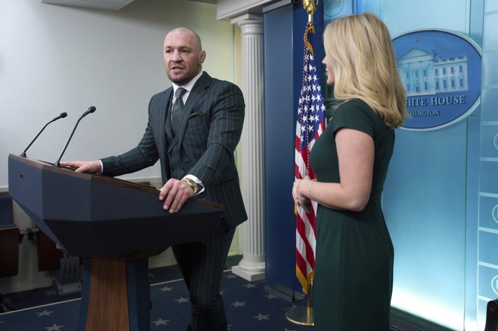White House press secretary Karoline Leavitt listens as UFC fighter Conor McGregor speaks with reporters in the briefing room of the White House, Monday, March 17, 2025, in Washington. (AP Photo/Evan Vucci)