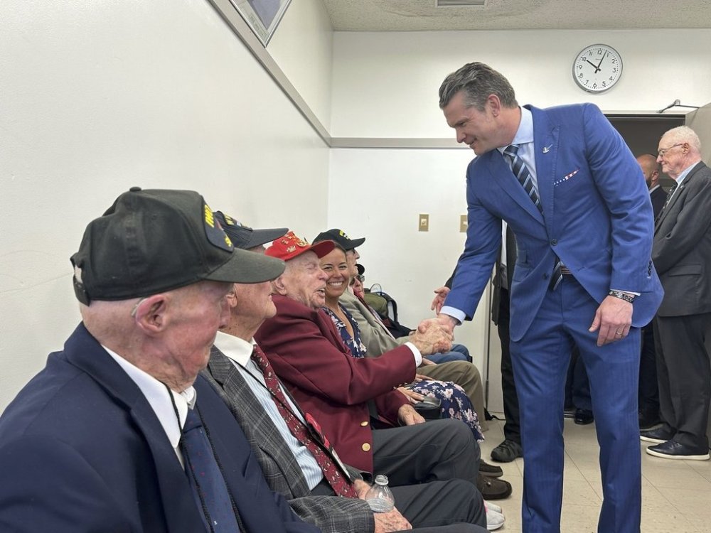 In this photo provided by the Iwo Jima Association of America, U.S. Secretary of Defense Pete Hegseth greets veterans including Charles Cram, Hegseth is shaking hands with, a former Marine, who fought on Iwo Jima, during the 80th Reunion of Honor ceremony on Iwo Jima, now known as Iwoto, or Iwo island, Japan, Saturday, March 29, 2025. (Iwo Jima Association of America via AP)