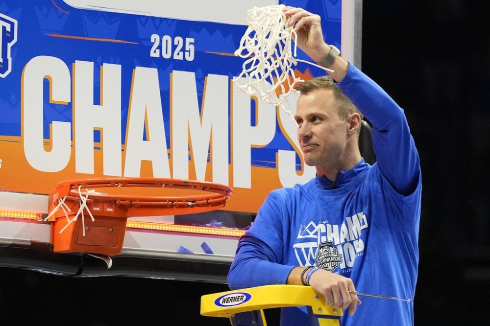 Duke head coach Jon Scheyer cuts the net after their win against Louisville after an NCAA college basketball game in the championship of the Atlantic Coast Conference tournament, Saturday, March 15, 2025, in Charlotte, N.C. (AP Photo/Chris Carlson)