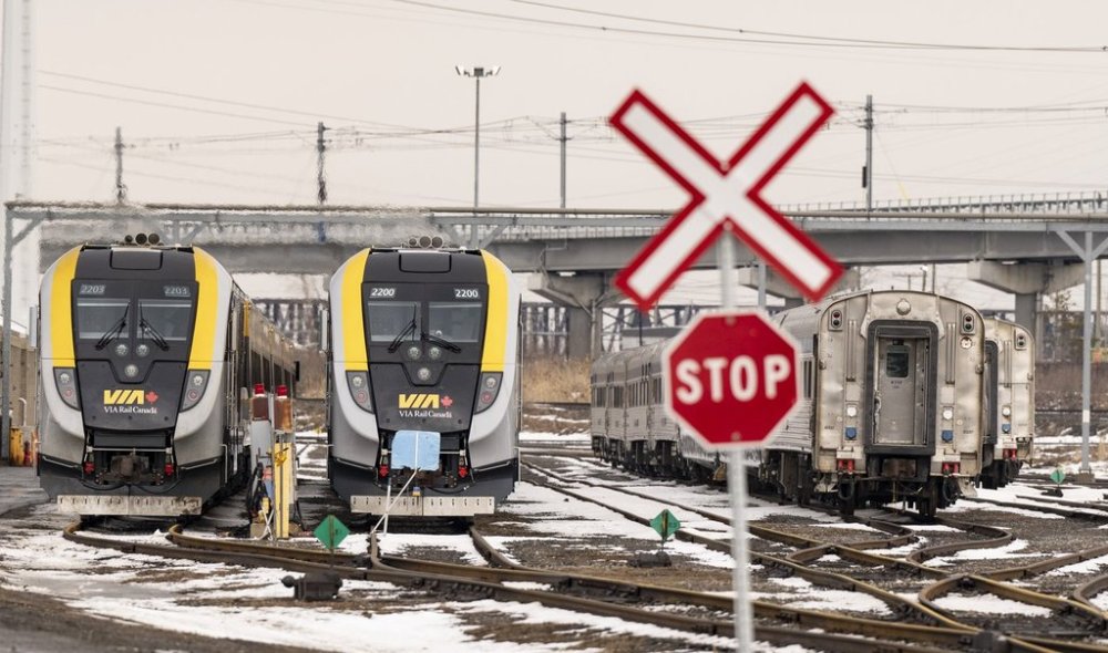 New passenger trains, left, sit on the tracks at the Via Rail Canada Maintenance Centre in Montreal, Thursday, Feb. 22, 2024. THE CANADIAN PRESS/Christinne Muschi