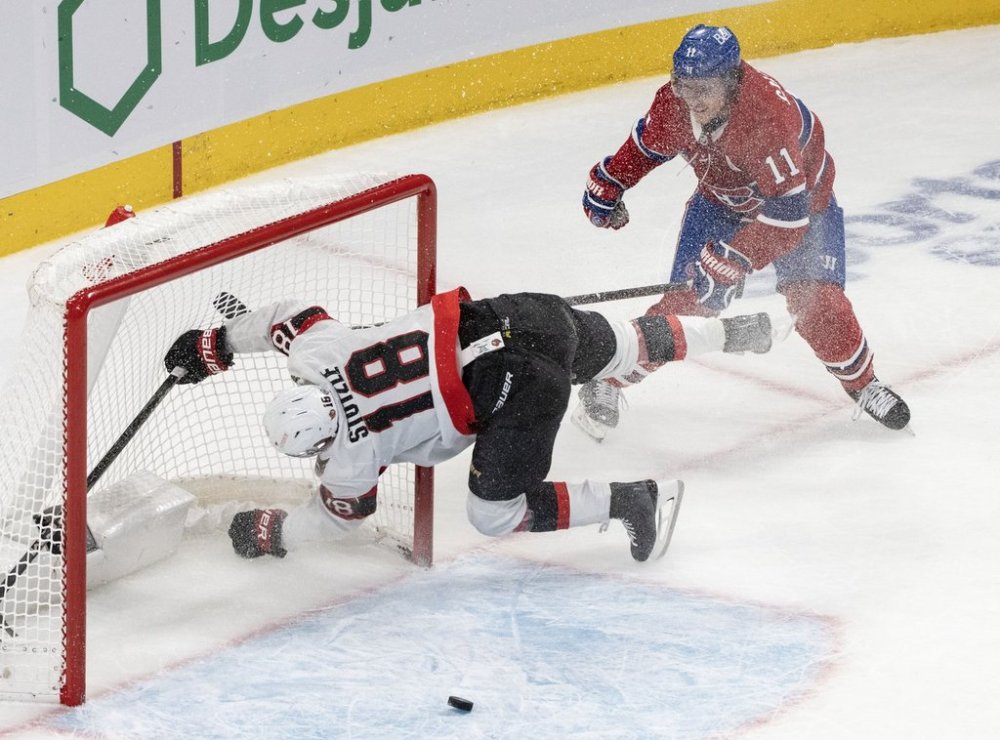 Ottawa Senators' Tim Stutzle (18) crashes into the net after Montreal Canadiens' Brendan Gallagher (11) scores an empty net goal during third period NHL hockey action in Montreal on Tuesday, March 18, 2025. THE CANADIAN PRESS/Christinne Muschi