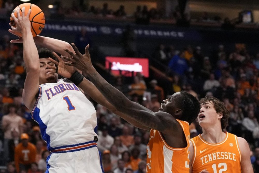 Florida guard Walter Clayton Jr. (1) takes a rebound against Tennessee forward Felix Okpara (34) during the first half of an NCAA college basketball game in the final round of the Southeastern Conference tournament, Sunday, March 16, 2025, in Nashville, Tenn. (AP Photo/George Walker IV)
