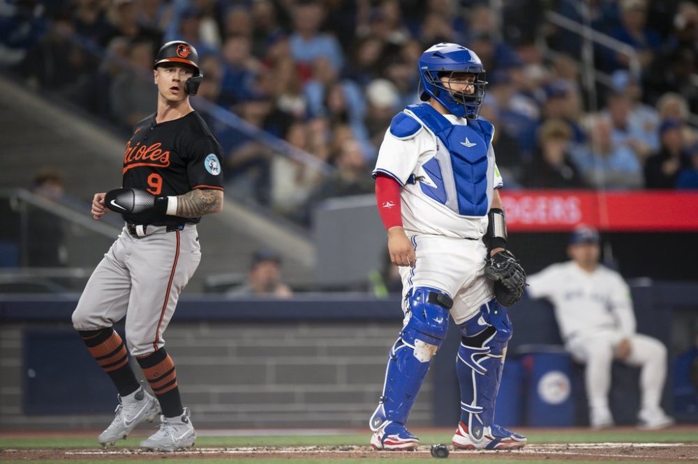 Baltimore Orioles outfielder Tyler O'Neill (9) scores during second inning MLB baseball action against the Toronto Blue Jays, in Toronto on Thursday, March 27, 2025. THE CANADIAN PRESS/Christopher Katsarov
