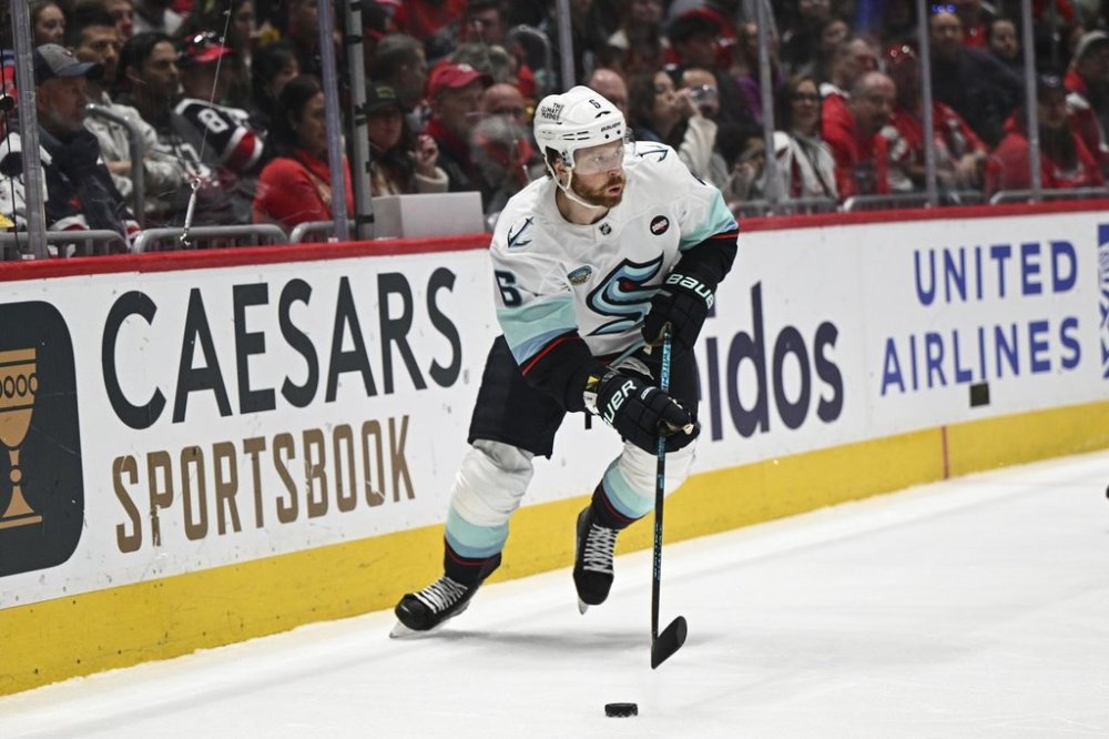 Seattle Kraken defenseman Adam Larsson (6) skates with the puck during the first period of an NHL hockey game against the Washington Capitals, Sunday, March 9, 2025, in Washington. (AP Photo/Terrance Williams)
