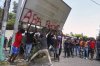 Protesters try to pull down a sign during a protest against insecurity in Port-au-Prince, Haiti, Wednesday, April 2, 2025. (AP Photo/Odelyn Joseph)