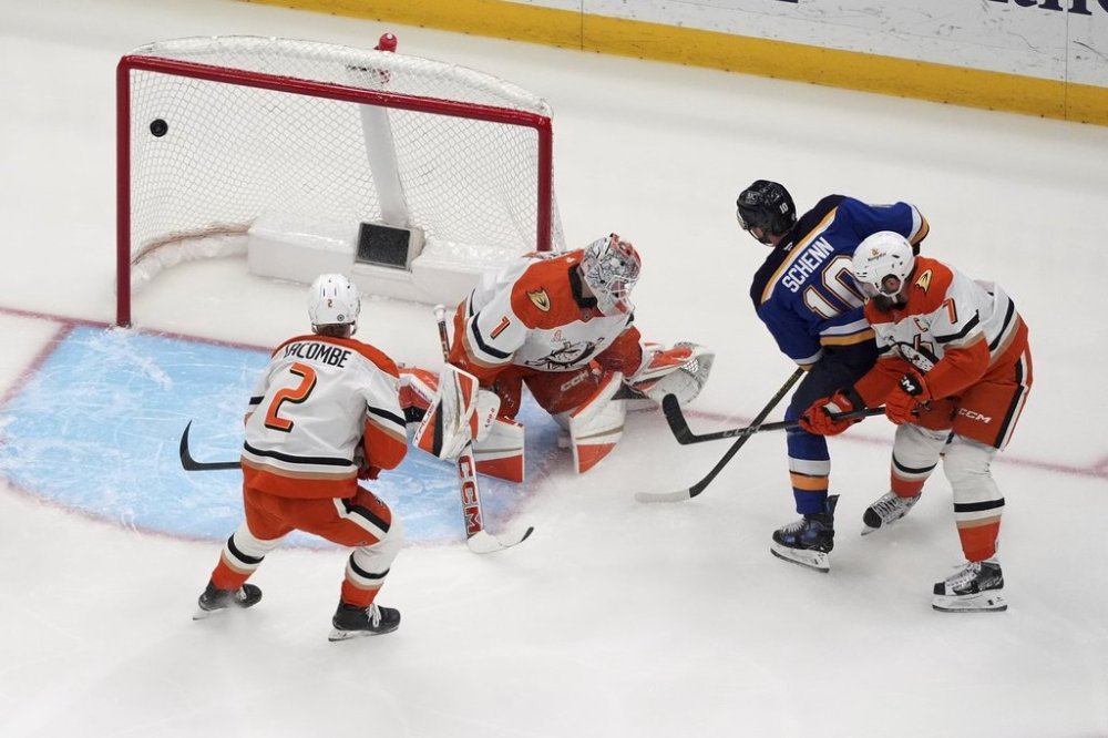 St. Louis Blues' Brayden Schenn (10) scores past Anaheim Ducks goaltender Lukas Dostal (1) as Ducks' Jackson LaCombe (2) and Radko Gudas (7) watch during the first period of an NHL hockey game Sunday, March 16, 2025, in St. Louis. (AP Photo/Jeff Roberson)