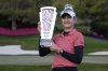 FILE - Nelly Korda poses with the trophy after winning the LPGA T-Mobile Match Play golf tournament Sunday, April 7, 2024, in North Las Vegas, Nev. (AP Photo/John Locher, File)