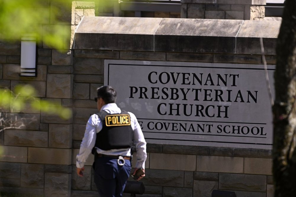 FILE - A police officer walks by an entrance to The Covenant School after a shooting in Nashville, Tenn. on Monday, March 27, 2023. (AP Photo/John Amis, File)