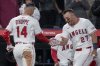Los Angeles Angels' Mike Trout (27) high fives Logan O'Hoppe (14) during the fifth inning of a baseball game against the Cleveland Guardians in Anaheim, Calif., Saturday, April 5, 2025. (AP Photo/Eric Thayer)