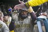 San Diego Padres' Fernando Tatis Jr. celebrates in the dugout after he scores during the eighth inning of a baseball game against the Chicago Cubs, Sunday, April 6, 2025, in Chicago. (AP Photo/Matt Marton)