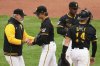 Pittsburgh Pirates pitcher Ryan Borucki, center, hands the ball to manager Derek Shelton, left, during the ninth inning of a baseball game New York Yankees in Pittsburgh, Sunday, April 6, 2025. (AP Photo/Gene J. Puskar)