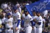 Members of the against the Los Angeles Dodgers from left, manager Dave Roberts, Freddie Freeman, Teoscar Hernández, Shohei Ohtani and Mookie Betts stand during ceremonies, prior to a home-opening baseball game against the Detroit Tigers, Thursday, March 27, 2025, in Los Angeles. (AP Photo/Mark J. Terrill)