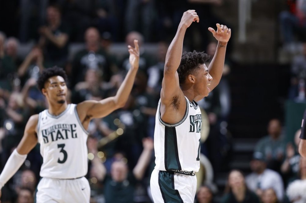 Michigan State guards Jeremy Fears Jr., right, and Jaden Akins (3) celebrate during the second half of an NCAA college basketball game against Wisconsin, Sunday, March 2, 2025, in East Lansing, Mich. (AP Photo/Al Goldis)