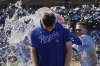 Kansas City Royals starting pitcher Kris Bubic, center, is doused by teammates after their baseball game against the Baltimore Orioles, Sunday, April 6, 2025, in Kansas City, Mo. (AP Photo/Charlie Riedel)