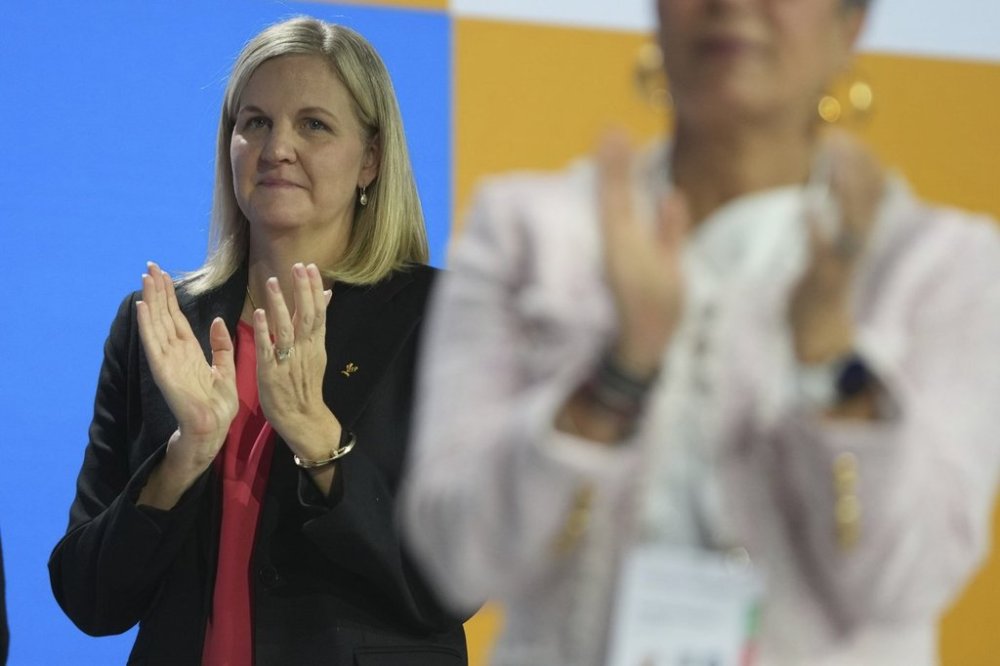 IOC President-elect Kirsty Coventry applauds during the International Olympic Committee 144th session in Costa Navarino, western Greece, Friday, March 21, 2025. (AP Photo/Thanassis Stavrakis)