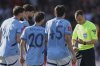 Referee Stuart Attwell, right, discusses with Manchester City players during the English FA Cup quarterfinal soccer match between Bournemouth and Manchester City at the Vitality stadium in Bournemouth, England, Sunday, March 30, 2025. (AP Photo/Ian Walton)