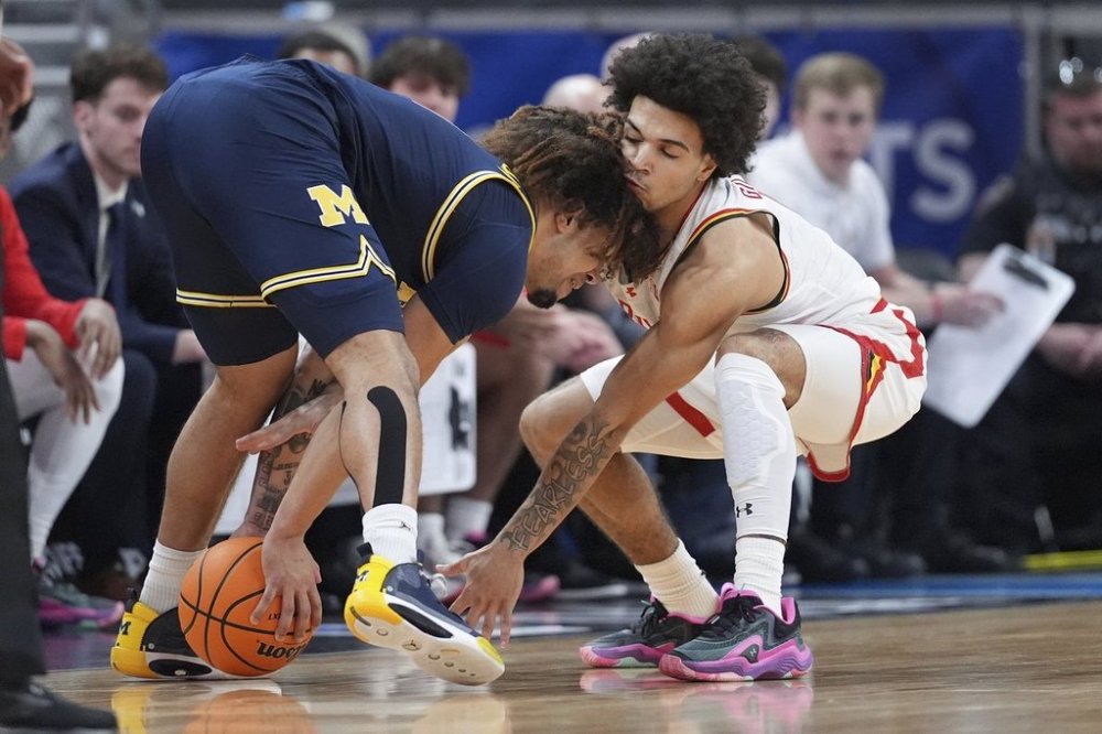 Michigan Wolverines guard Tre Donaldson (3) collects the ball as Maryland guard Ja'Kobi Gillespie (0) attempts a steal during the first half of an NCAA college basketball game in the semifinals of the Big Ten Conference tournament in Indianapolis, Saturday, March 15, 2025. (AP Photo/Michael Conroy)