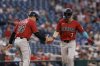 Arizona Diamondbacks' Corbin Carroll (7) is greeted by third base/infield coach Shaun Larkin (88) after hitting a solo home run off Washington Nationals pitcher Jake Irvin during the third inning of a baseball game in Washington, Friday, April 4, 2025. (AP Photo/Terrance Williams)