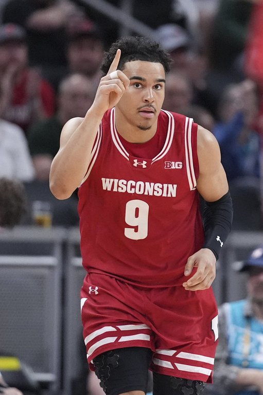 Wisconsin guard John Tonje (9) reacts to a basket against UCLA during the first half of an NCAA college basketball game in the quarterfinals of the Big Ten Conference tournament in Indianapolis, Friday, March 14, 2025. (AP Photo/Michael Conroy)
