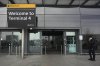 A traveller speaks on the phone at the entrance to Terminal 4 as Britain's Heathrow Airport has closed for the full day Friday after an electrical substation fire knocked out its power, disrupting flights for hundreds of thousands of passengers at one of Europe's biggest travel hubs in London, Friday, March 21, 2025. ASSOCIATED PRESS/Kin Cheung