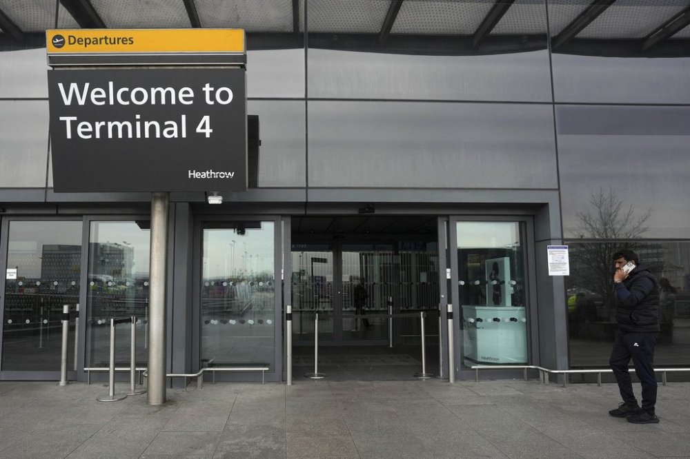 A traveller speaks on the phone at the entrance to Terminal 4 as Britain's Heathrow Airport has closed for the full day Friday after an electrical substation fire knocked out its power, disrupting flights for hundreds of thousands of passengers at one of Europe's biggest travel hubs in London, Friday, March 21, 2025. ASSOCIATED PRESS/Kin Cheung