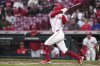 Cincinnati Reds' Matt McLain hits a two-run home run in the first inning of a baseball game against the Texas Rangers, Monday, March 31, 2025, in Cincinnati. (AP Photo/Kareem Elgazzar)