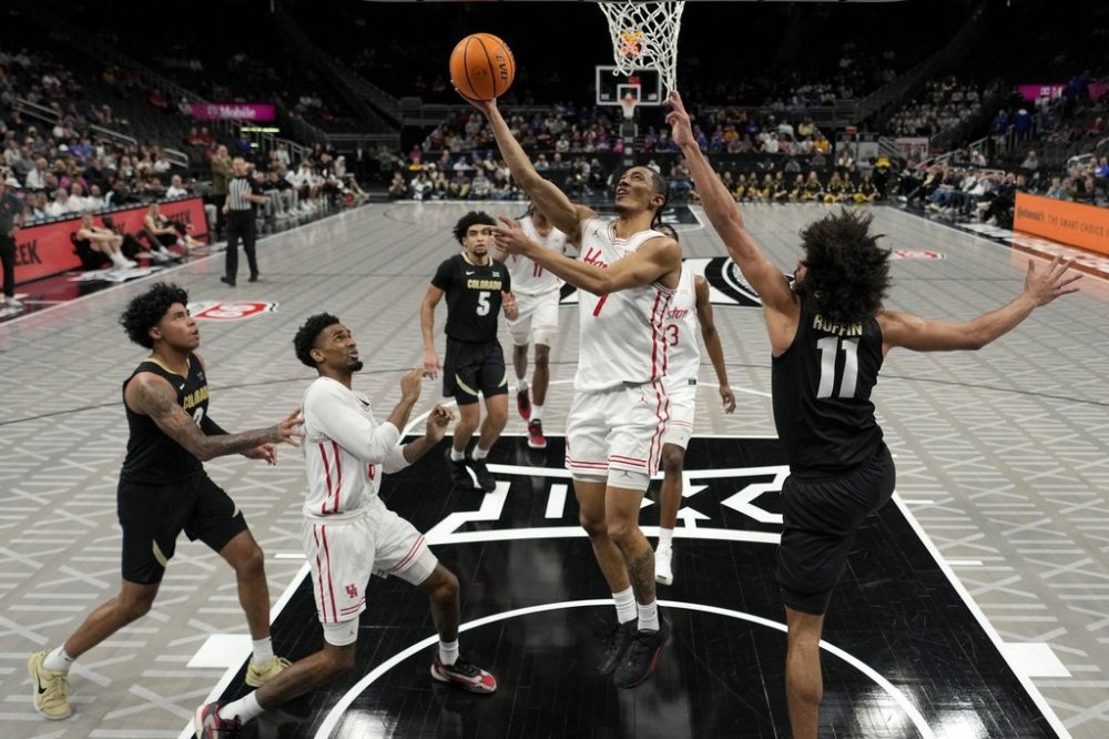 Houston guard Milos Uzan (7) puts up a shot during the second half of an NCAA college basketball game against Colorado in the Big 12 men's tournament Thursday, March 13, 2025, in Kansas City, Mo. (AP Photo/Charlie Riedel)