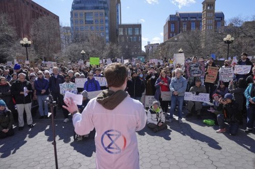 People listen to Griffin Gowdy, a PhD student at Columbia University, speak during a 